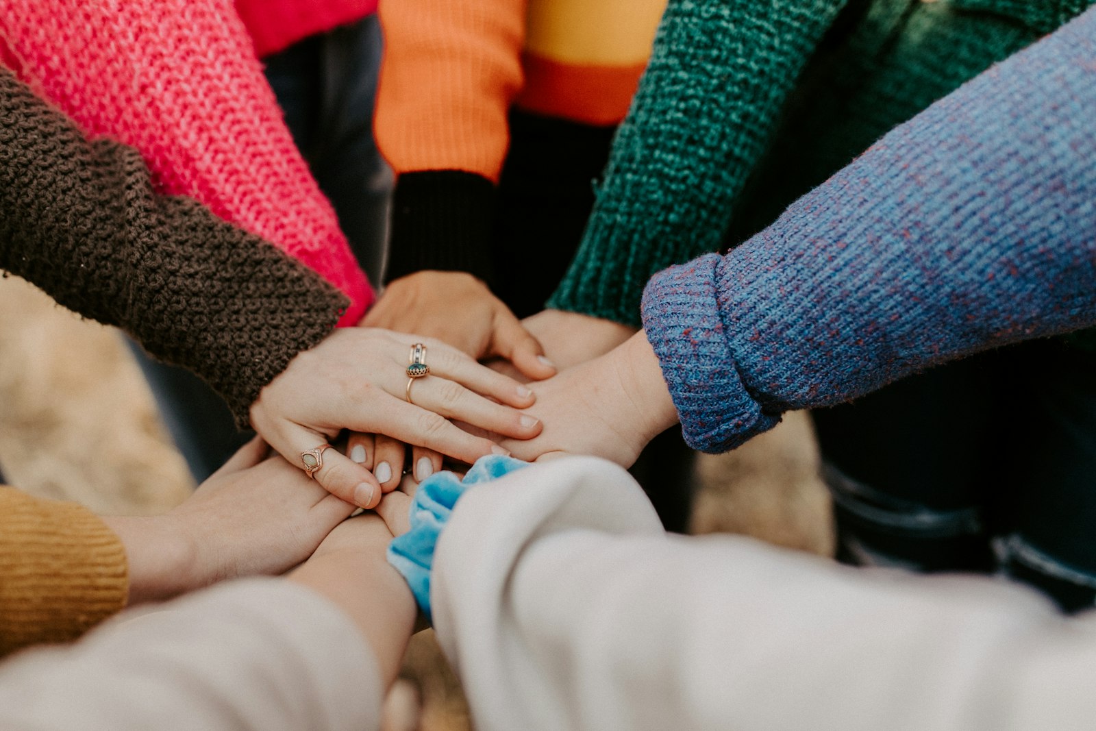 Hands stacked together in a show of community